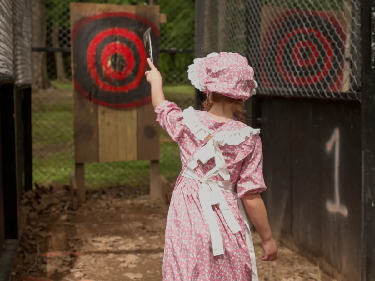 Axe throwing on the grounds under the trees
